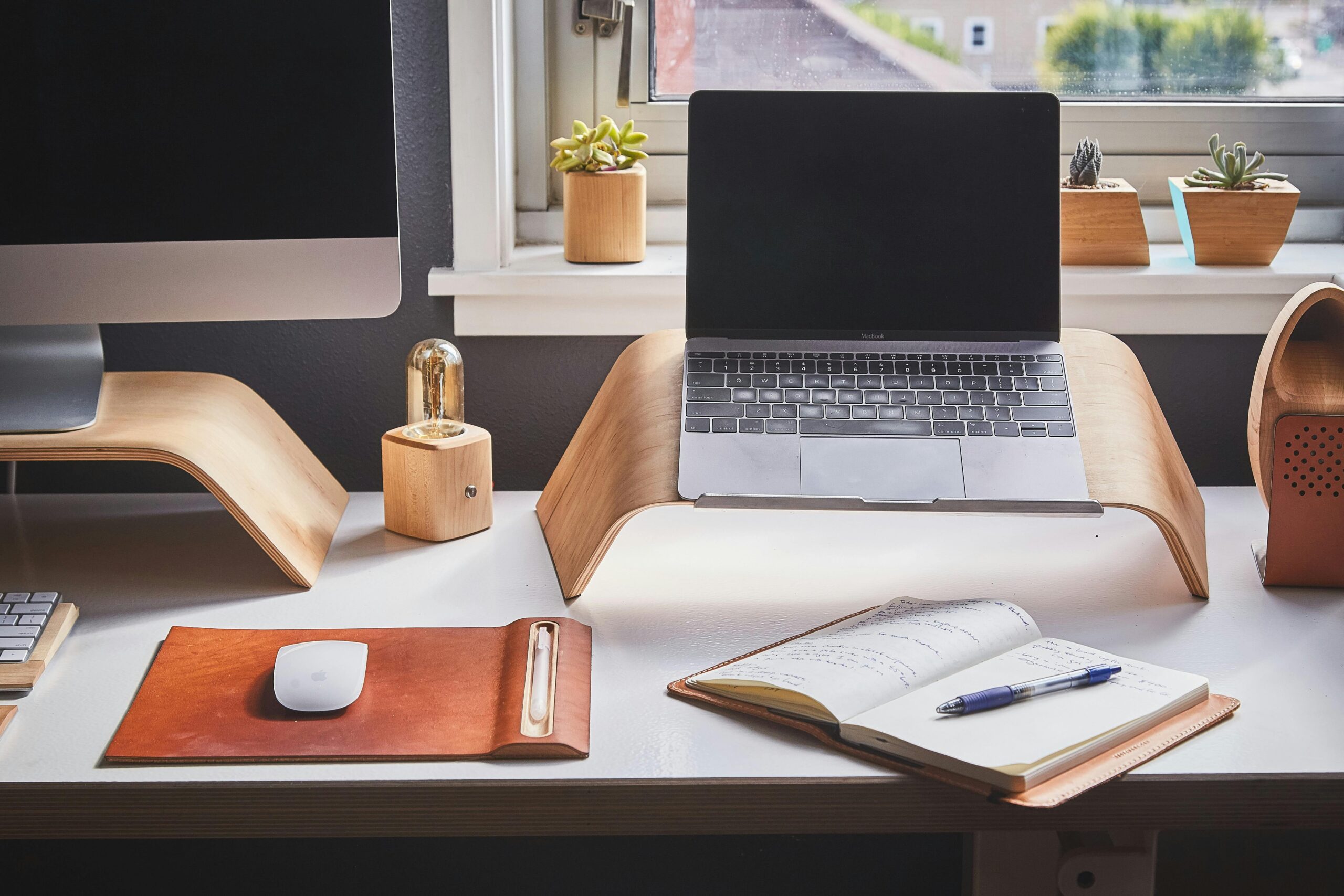 A stylish and contemporary home office setup with laptop and desk accessories.